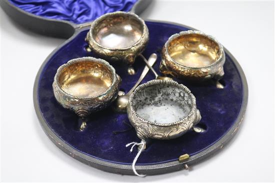 A matched set of four 18th century later embossed silver bun salts, in case with two associated spoons.